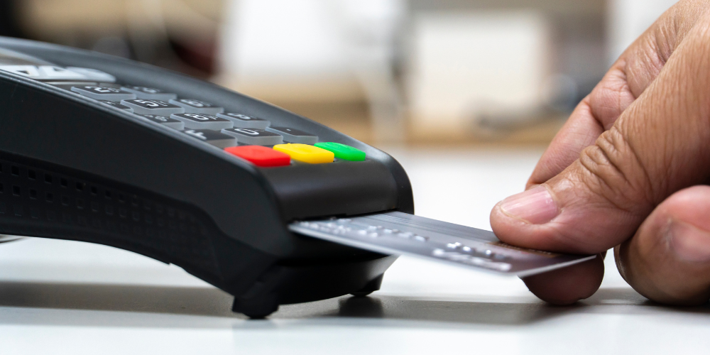 credit card being swiped in credit card machine