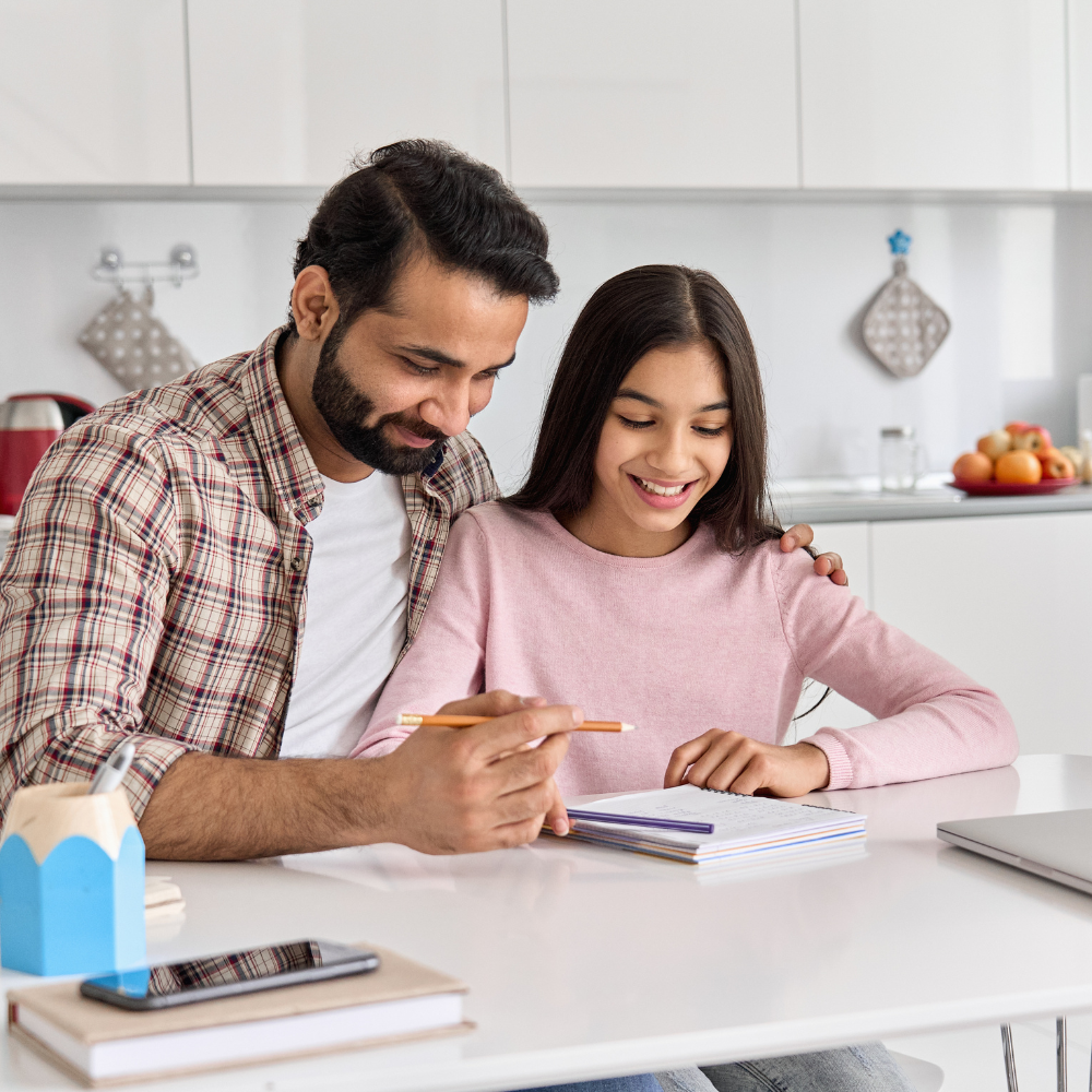 father and daughter writing on a notebook