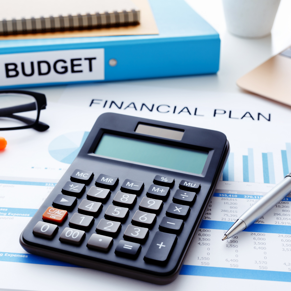 calculator, binder, paper, pen, and glasses