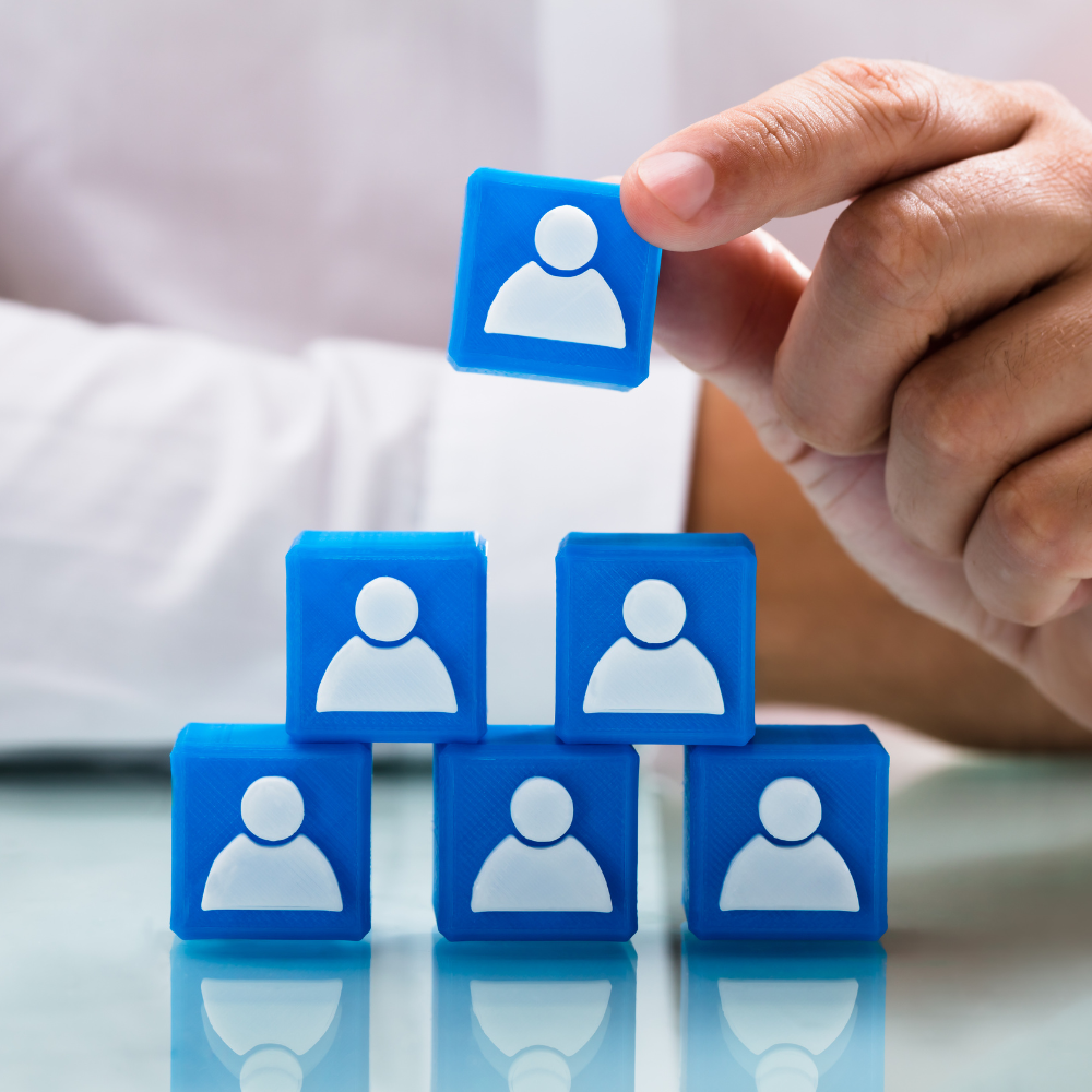 person holding people icon and block pyramid