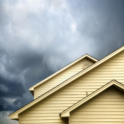 yellow house and dark storm clouds